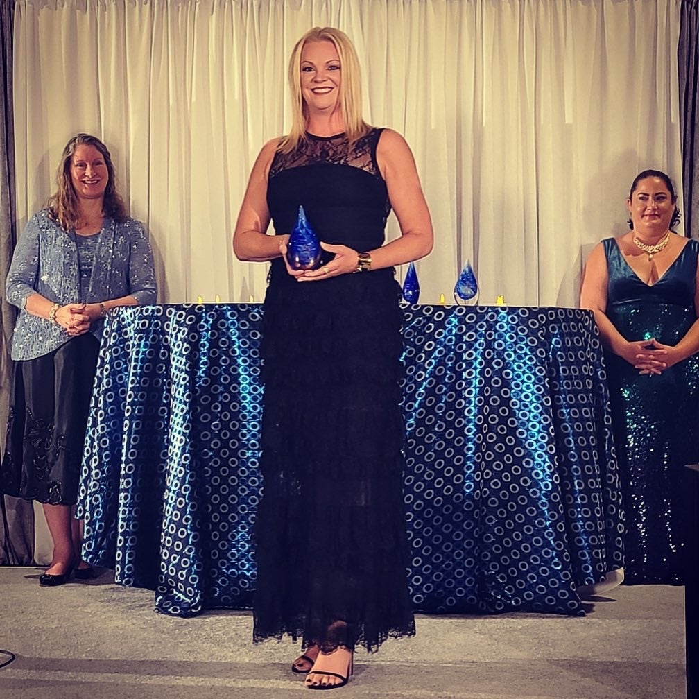 Carrie Potter holding award