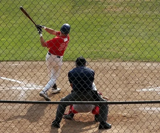 view of athletes playing baseball in the field